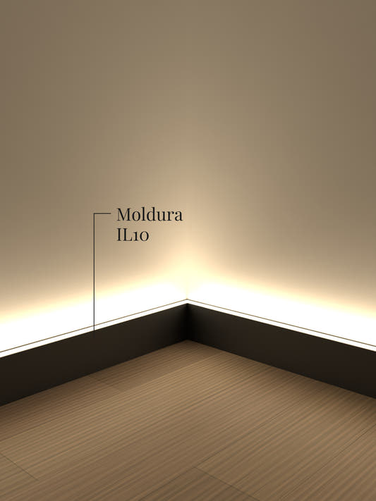 Moldura de luz indirecta IL10 negra en un rincón a ras de piso, con la cinta LED encendida bañando el muro de luz
