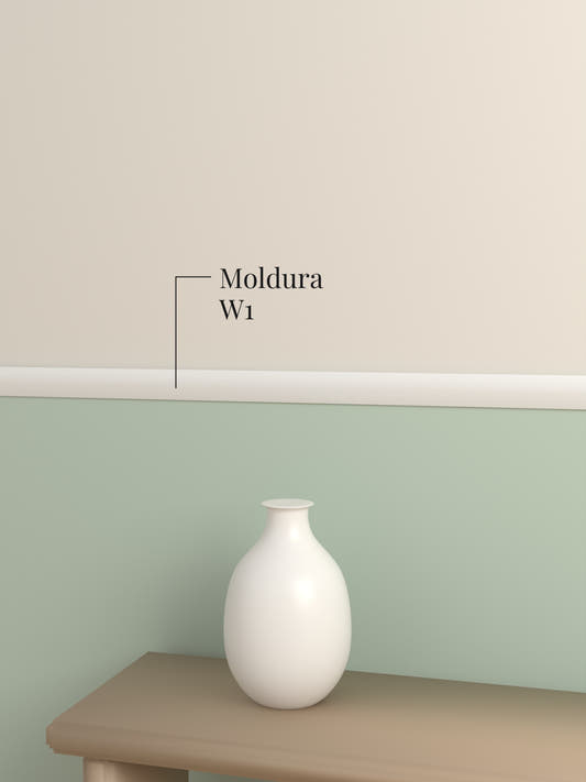 Moldura W1 como guardasilla blanca entre un muro verde salvia y otro beige, sobre un banco con un florero