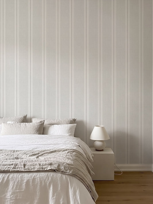 Papel mural Henry White, sobrio diseño de rayas verticales de distinto ancho en blanco y gris perla. Ideal para baños y cocinas.